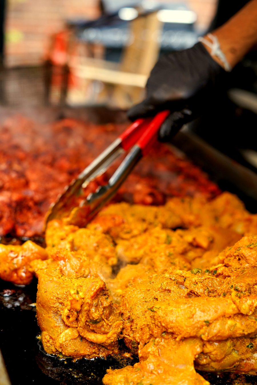 Chicken tikka cooking on the grill at a corporate event