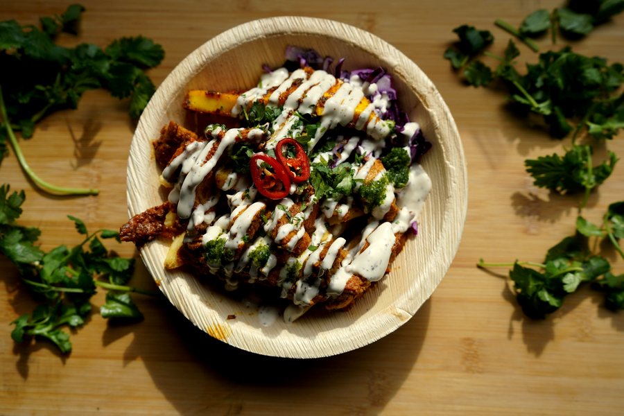 A guest collecting a kata bowl at a KoolKata street food station